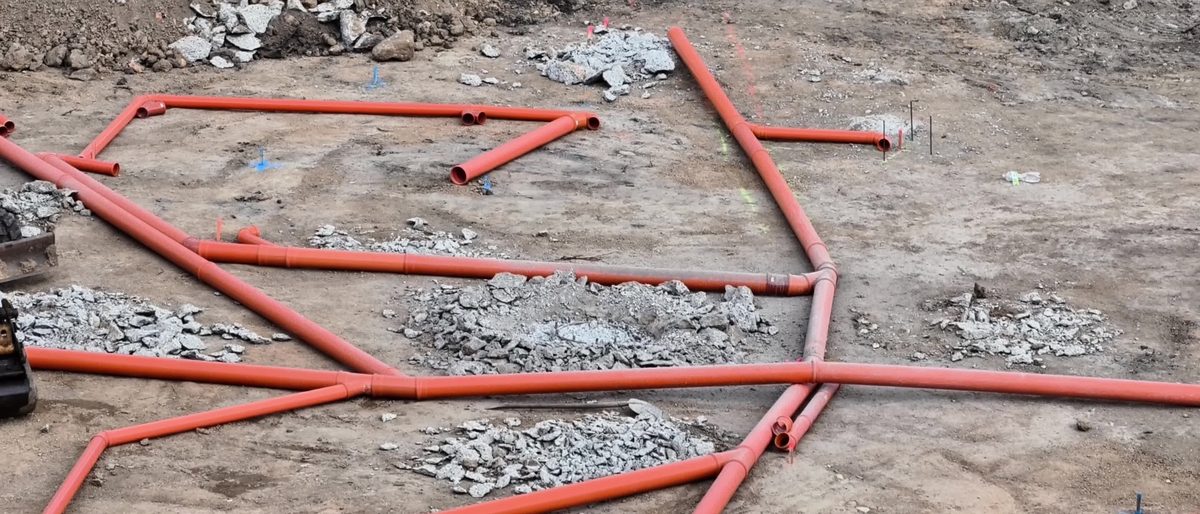 Drainage pipework laid out on a sub-base before the concrete is poured